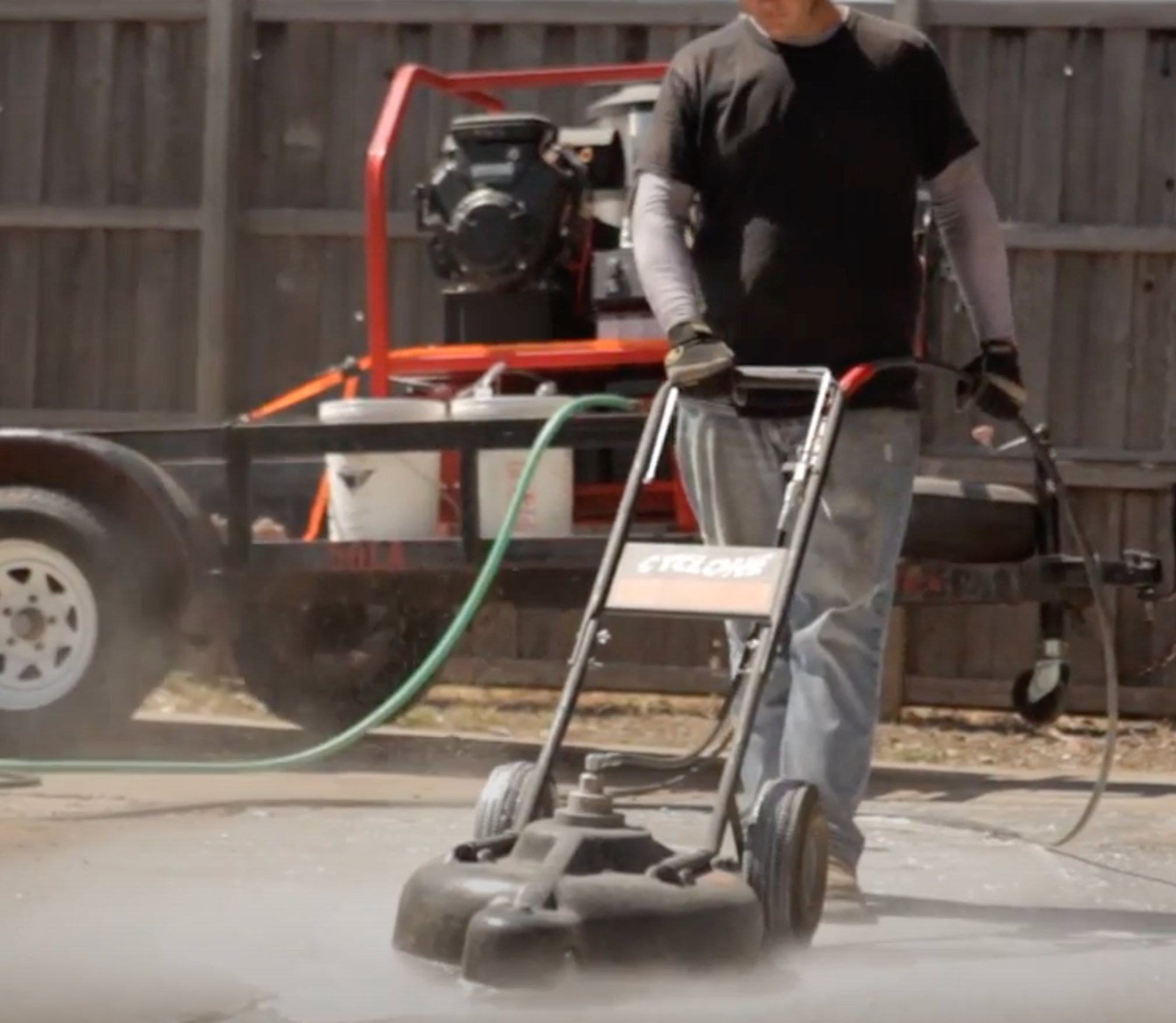 Man pressure washing concerte 