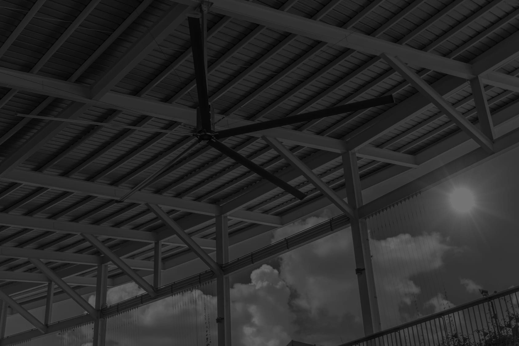 Black and white image of large industrial ceiling fan