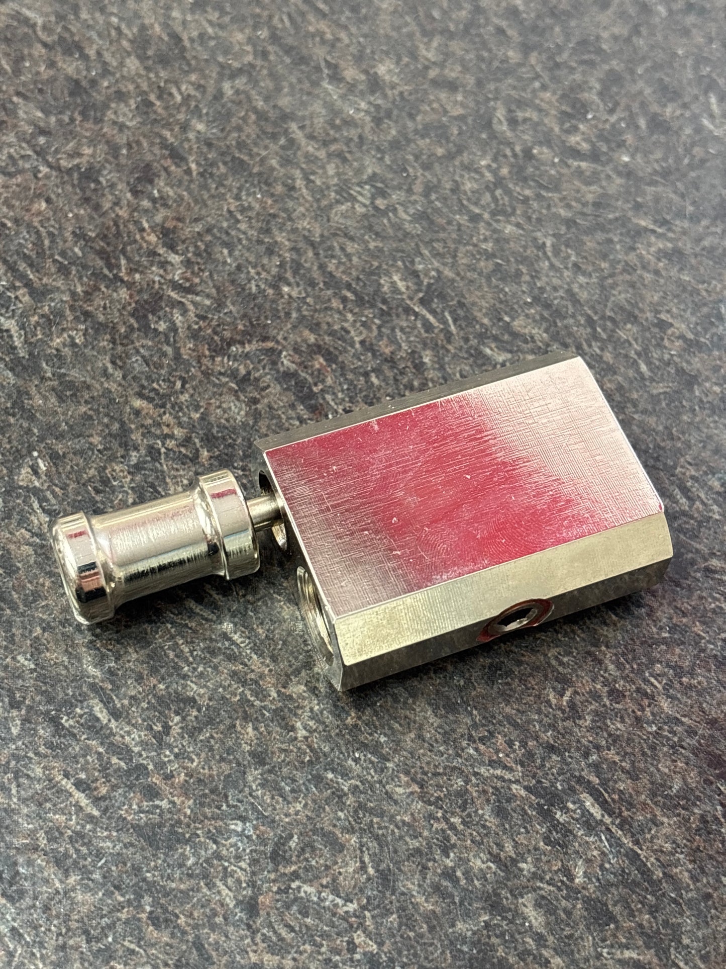 Metal component with red oxide on a gray surface