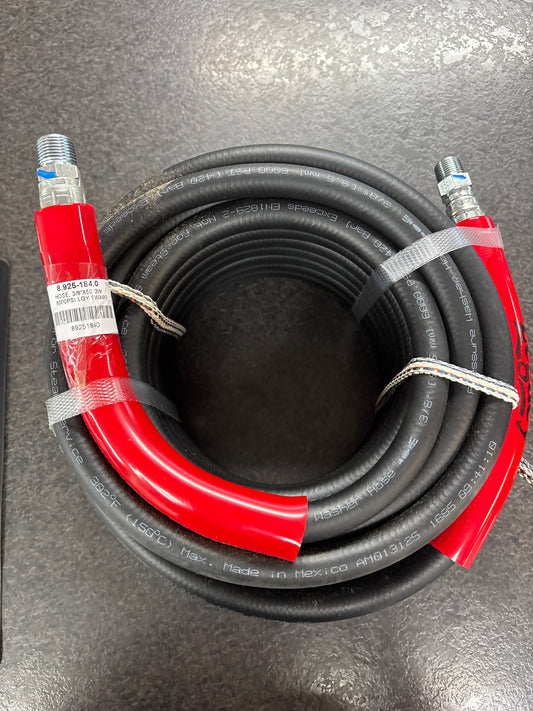Coiled black and red air hose on a gray surface