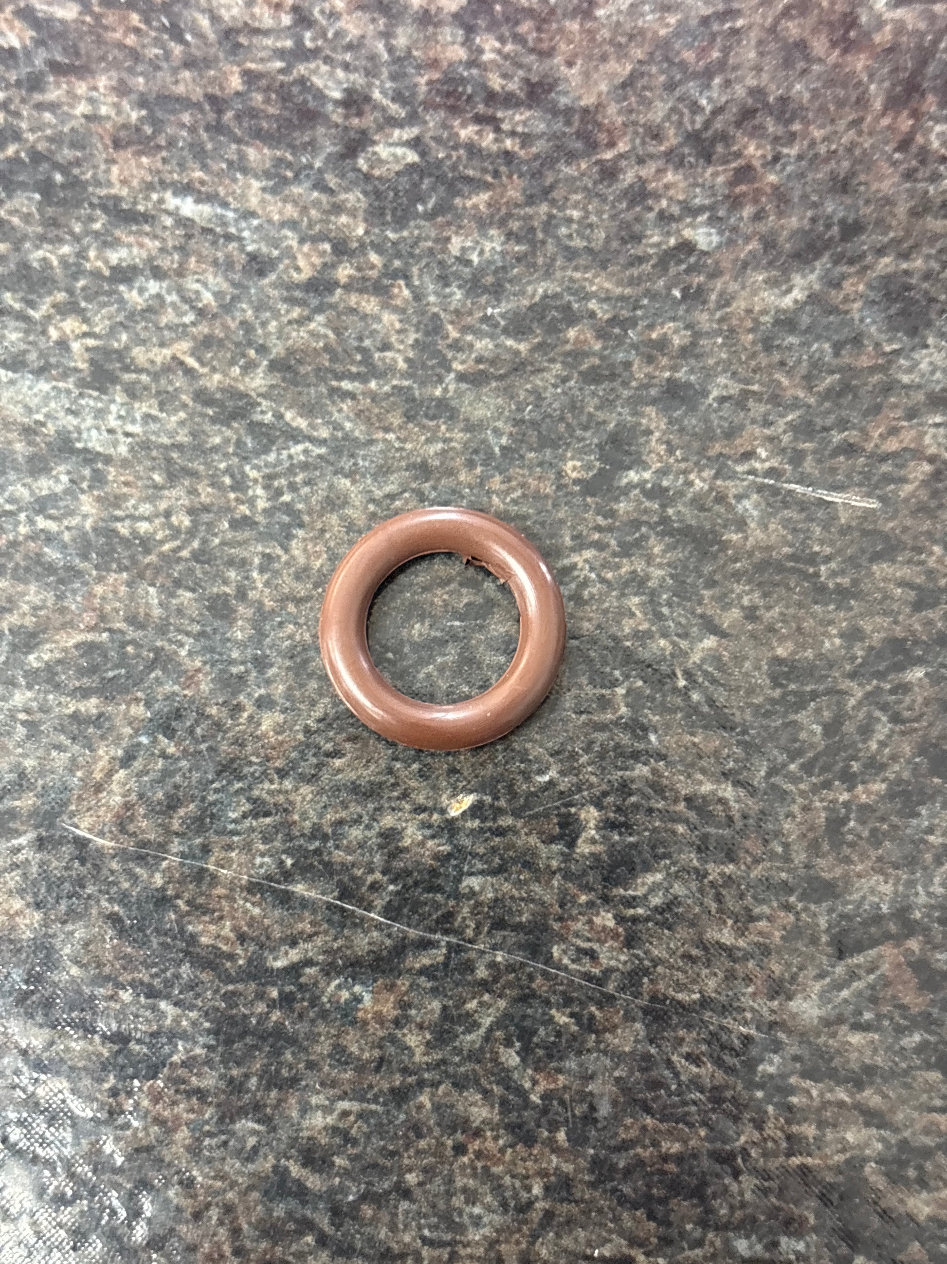Bronze washer on a textured gray surface