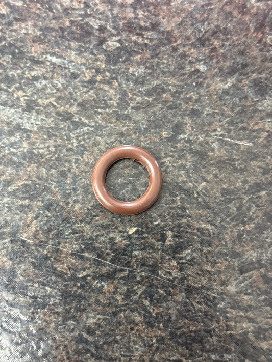 Bronze washer on a textured gray surface