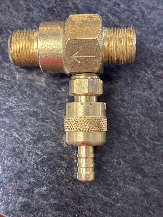 Brass plumbing fitting on a dark textured background