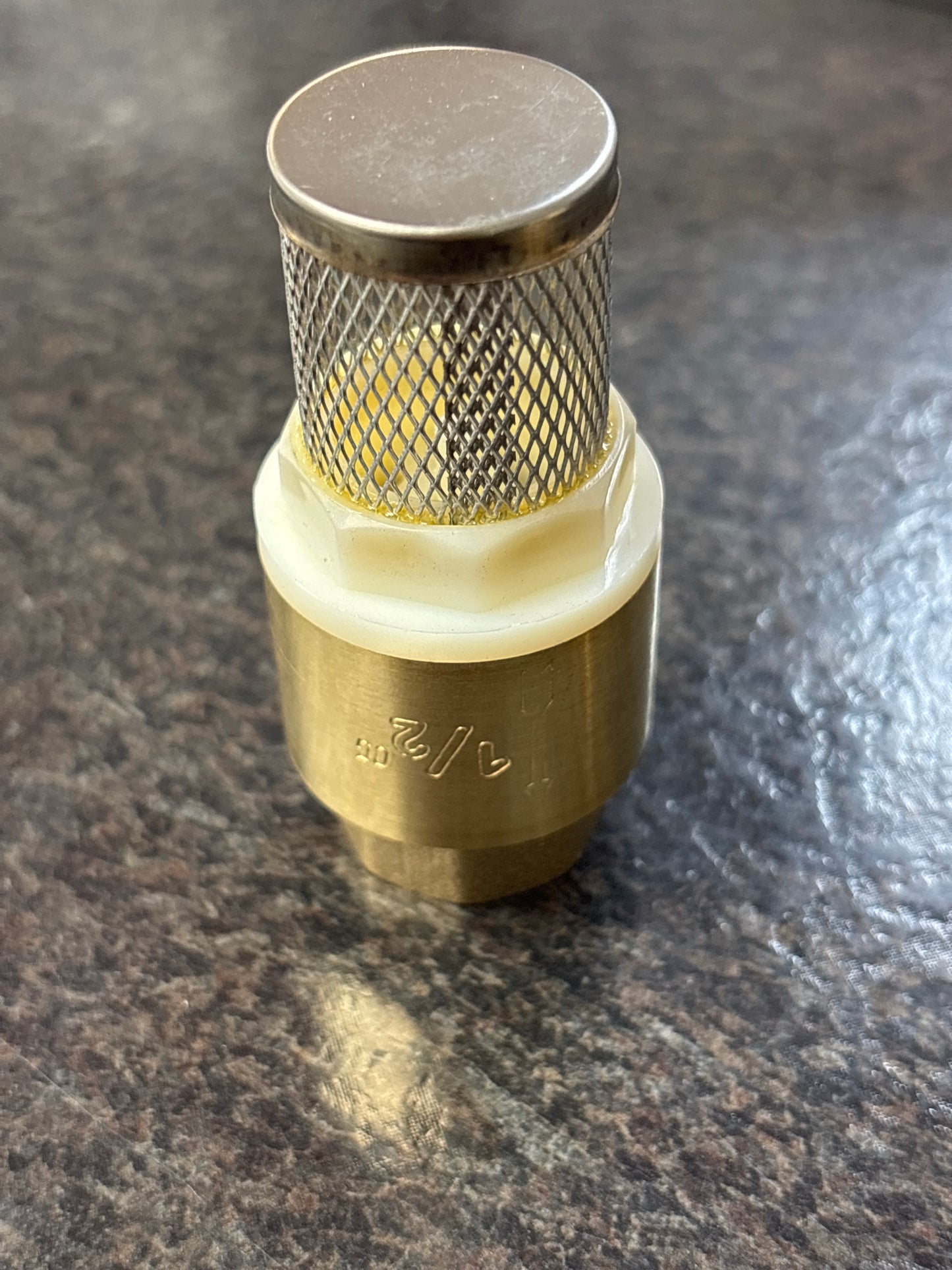 Brass fitting on a dark surface