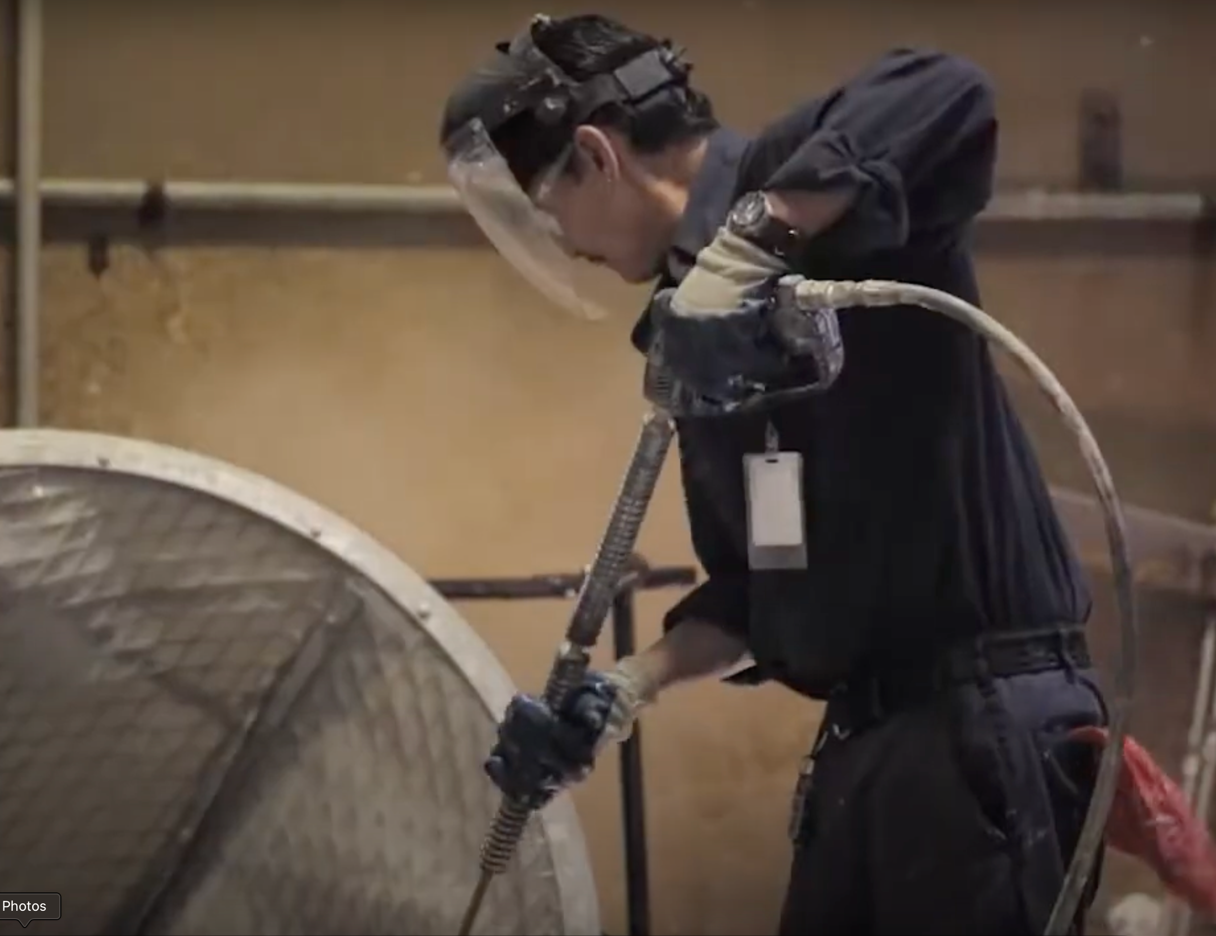 Man with safety visor pressure washing equipment